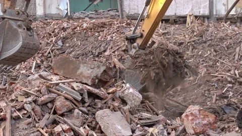 Excavators disassembles the wreckage of an old building, demolished to build  Stock Footage 161914438