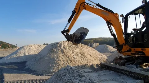 Excavators level the site with sand, moving sand from the mounds Stock Footage 122622452