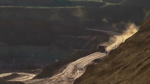 Excavators load ore into dump-trucks. This area has been mined for buaxite Stockbeeldmateriaal 75391314