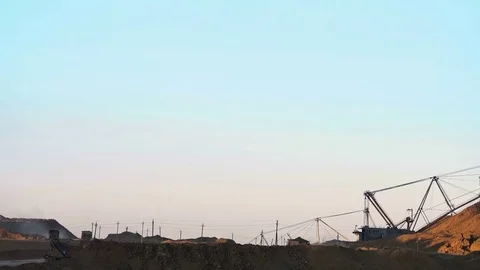 Excavators load ore into dump-trucks. This area has been mined for buaxite Stock Footage 75577650