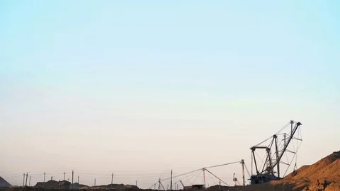 Excavators load ore into dump-trucks. This area has been mined for buaxite Stockbeeldmateriaal 75578128