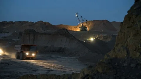 Excavators load ore into dump-trucks. This area has been mined for buaxite Video stock 75580245