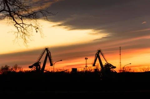 Excavators for loading coal on the background of the setting sun. Stock Photos