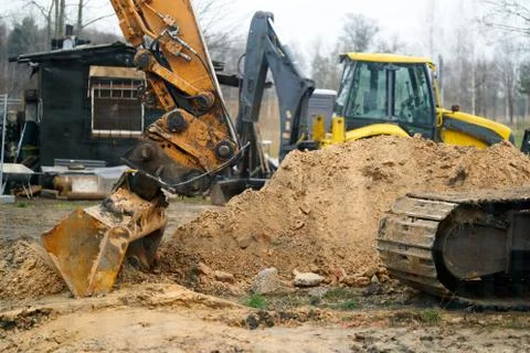 Excavators machine in construction site on sky background Stock Photos