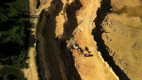 Excavators Operating in a Stone Quarry Surrounded by Greenery Excavators at work Stock Photos