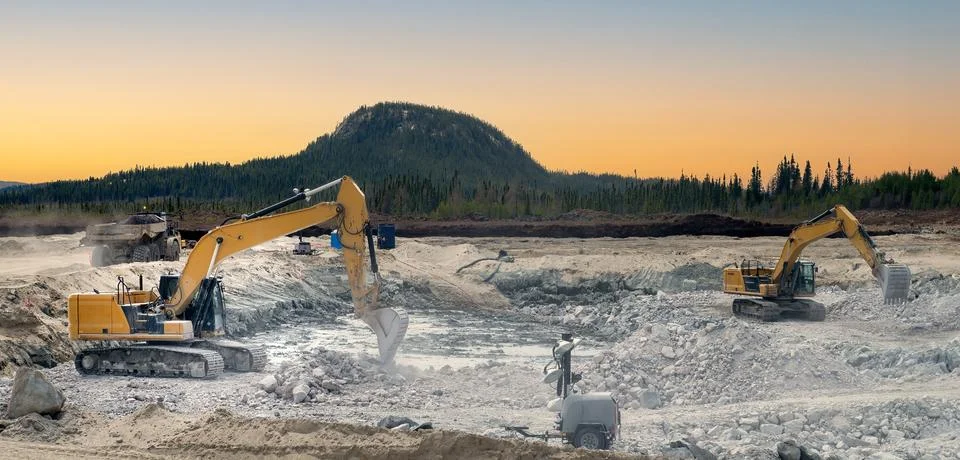 Excavators at sunset Stock Photos