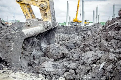 Excavator's tool, bucket, blade, cloudy sky behind Stock Photos