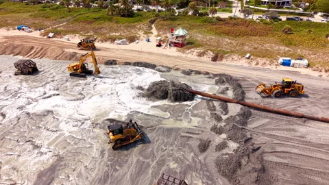 Excavators track loaders preading sand on Delray Beach renourishment 2026 Stock Footage 329448219