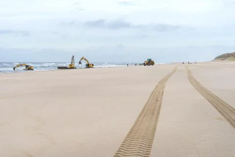 Excavators work on the beach Stock Photos