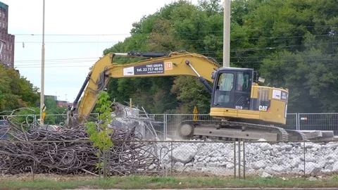 Excavators work on raking concrete blockages at a construction site in the city. Stock Footage 114322208