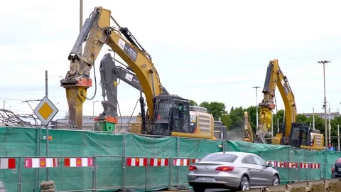 Excavators work on raking concrete blockages at a construction site in the city. Video stock 114323846