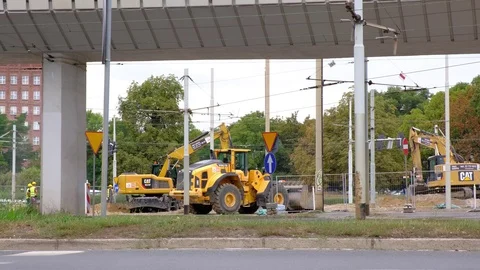 Excavators work on raking concrete blockages at a construction site in the city. Video stock 114323937