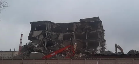 Excavators work, removing debris from the destroyed multi-storey building 動画素材 121056113