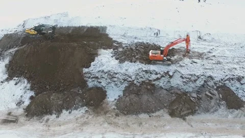 Excavators worked on dirt and snow Stock Footage 169323894