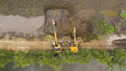 Excavators working on construction site Stock Photos