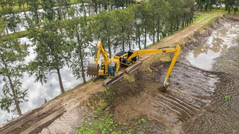 Excavators working on construction site Stock Photos