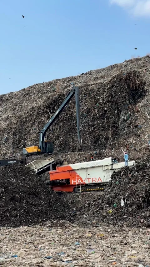 Excavators working at a large landfill site with birds flying Stock Footage 336067549