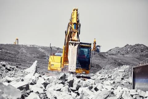 Excavators is working in the mine - selective focus Stock Photos