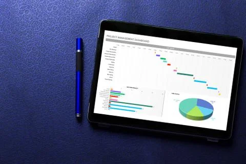 Excel project dashboard concept on tablet screen with blue pen on blue pattern  Stock Photos