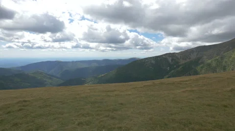 Excellent scenery of fields and mountains on a cloudy day on Transalpina Stock Footage 57792309