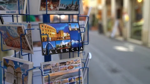 Excellent slow motion panning shot of an image of a tourist stall selling postca Stock Footage