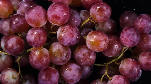 Excellent top view of bunch of grapes, water sprinkling and rotating Stock Footage 73870776