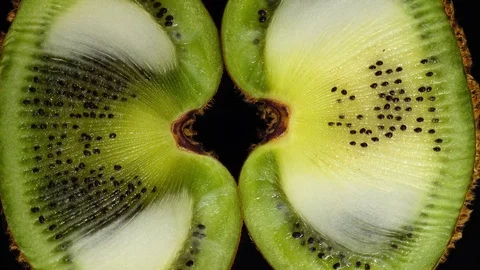 Excellent top view close up of fresh cut kiwi-fruit, rotating clockwise. Stock Footage 77718849