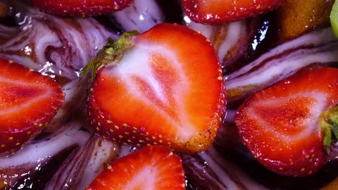Excellent top-view of sliced fresh strawberries close up, laying on iced cake Stock Footage 78353490