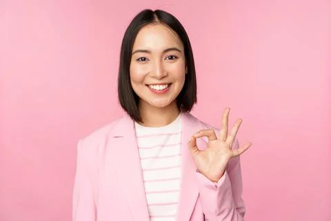 Excellent work, well done gesture. Smiling asian businesswoman showing okay, ok Stock Photos