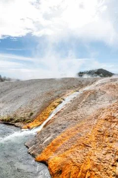 Excelsior Geyser flowing into the Firehole River at Yellowstone National Park Stock Photos