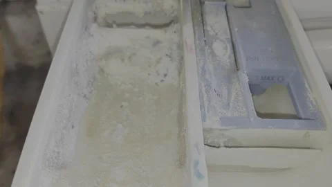 Excess laundry detergent powder overflowing from automatic washer dispenser. Stock Footage 335195767