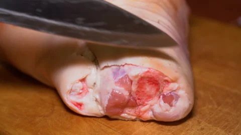 The excess is removed from the pork knuckle Stock Footage 249597462