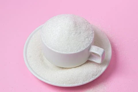 Excessive sugar intake. Sugar on a pink background.  Stock Photos