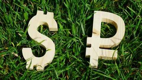 Exchange currency unit on a grass background Stock Photos