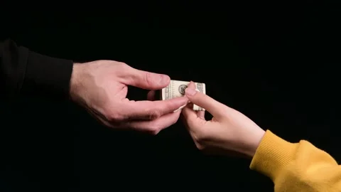 Exchange of a dose of a drug for money on a black background Stock Footage