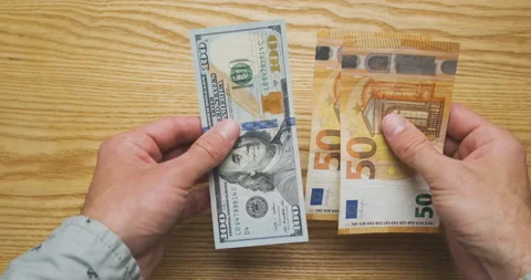 Exchange one hundred dollars for one hundred euros. Exchange rate has equalized Stock Footage 202017034