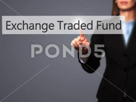 Exchange Traded Fund - Businesswoman hand pressing button on tou Stock Photos