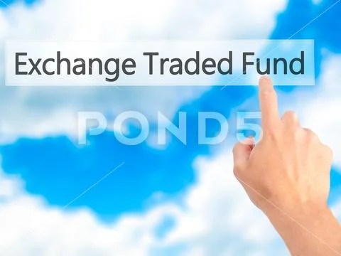 Exchange Traded Fund - Hand pressing a button on blurred backgro Stock Photos