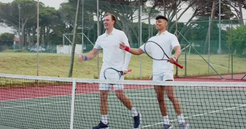 Exchanging looks sparking rally drop shot, Diverse men with rackets shaking Stock Footage 336957233