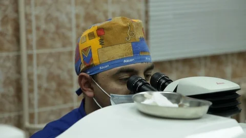 Excimer laser vision correction. the doctor looks through a microscope. Stock Footage 113781072