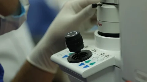 Excimer laser vision correction. doctor's hand on the joystick. Stock Footage 113781350