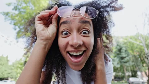 Excited african closely looking in camera and raising glasses outdoors 스톡 동영상 280169892