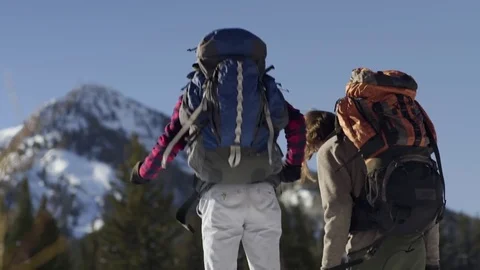 Excited Backpackers Jump Up And Down In Snow (Slow Motion) Stock Footage 72510473
