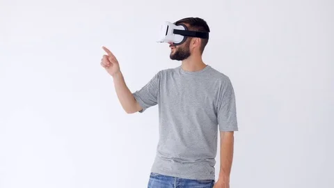 Excited bearded man using VR glasses trying to catch objects in virtual reality Stock Footage 85452364