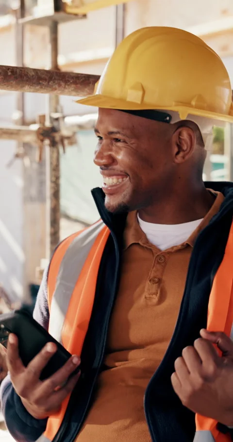 Excited, black man and engineer with phone at site for construction, good news Stock Footage 336229852