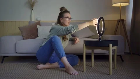 Excited blogger with smartphone and ring lamp during live video Stock Footage 141012364