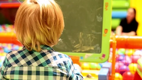 Excited boy learning to draw in playroom children entertainment center kids 스톡 동영상 113387831