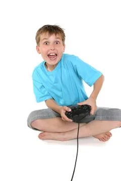 Excited boy playing a computer game Stock Photos