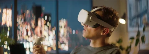 Excited Caucasian man using his VR virtual reality metaverse headset at home Stock Footage 209467572