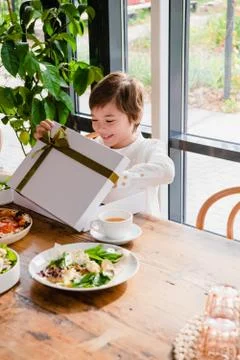 An excited child opens a nice present Stock Photos